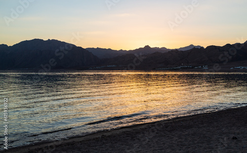 Beautiful sunset with orange sky in Lagoona beach, Dahab, Egypt photo