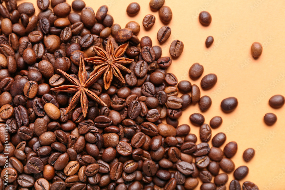 Scattered coffee beans with star anise on orange background