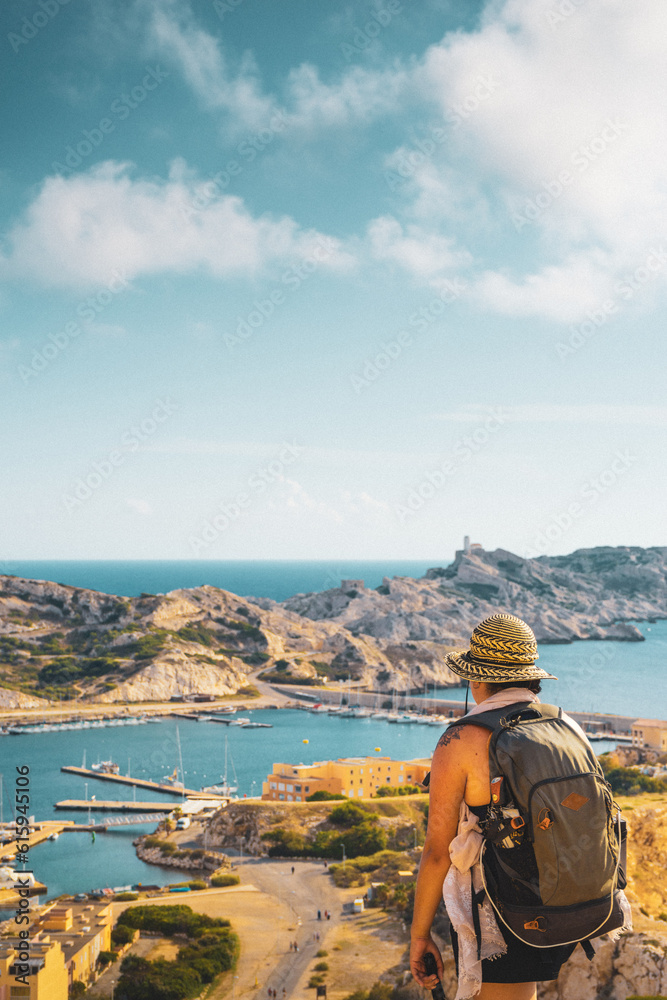 Obraz premium vertical traveler and tourist woman enjoy panoramic view of island and sea in summer sunset with freedom and wisdom in marseille france