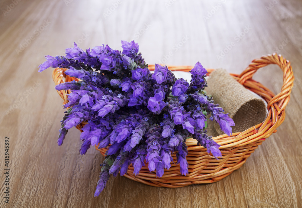 bundle of lavender flowers in wicker basket on vintage wooden table bundle of lavender flowers in wicker basket on vintage wooden table