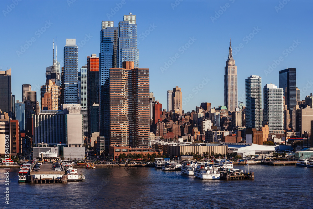 Photo of midtown Manhattan cityscape in New York city, taken from a ferry on the Hudson.