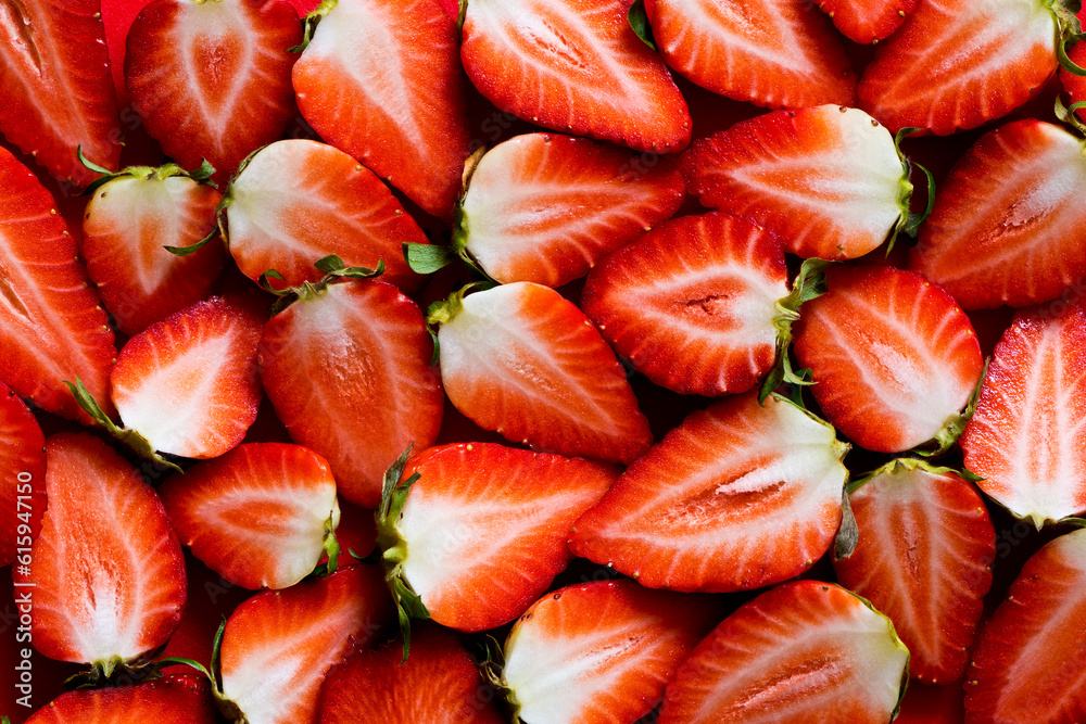 A shot of fresh strawberries sliced into halves. Top view. Background A shot of fresh strawberries sliced into halves. Top view. Background