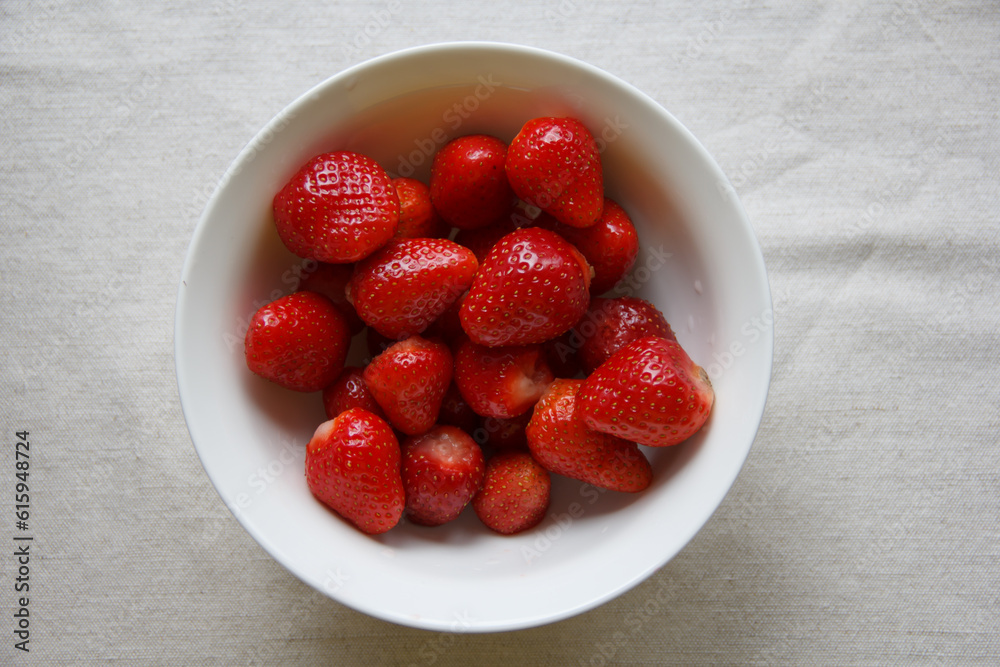 first strawberries from his garden in the white plate. selective focus first strawberries from his garden in the white plate. selective focus