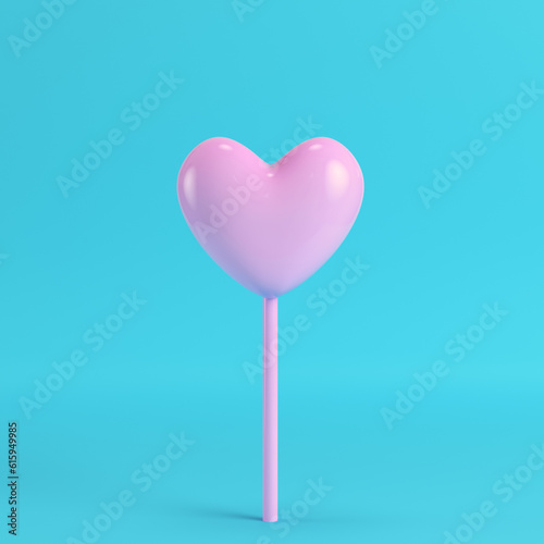 Pink heart on a stick on bright blue background in pastel colors. Minimalism concept. 3d render photo