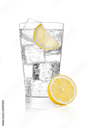 Glass of sparkling water soda drink lemonade with ice and lime lemon slice on white background