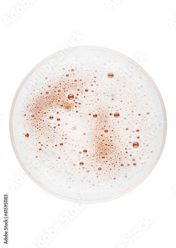 Glass of lager ale beer top view with foamon white background