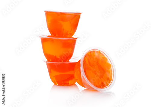 Single cups with mandarins in fruit jelly on white background