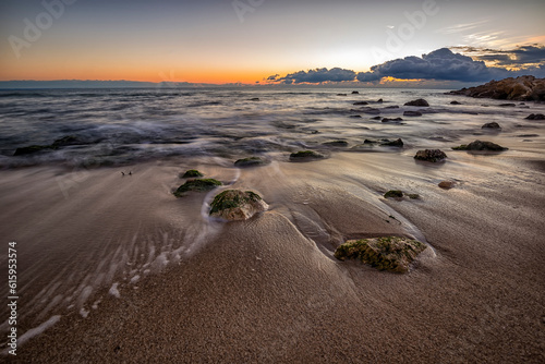 Fototapeta Naklejka Na Ścianę i Meble -  early morning at sea shore with stones on the beach