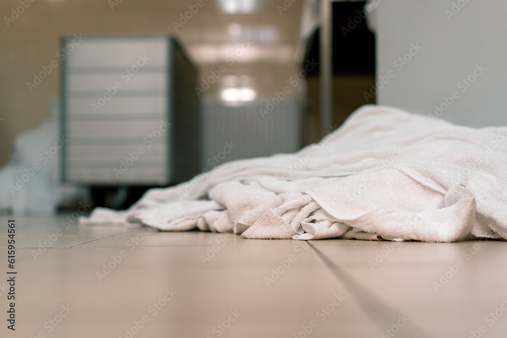industrial laundry in a hotel dirty bed linen lies on the floor sorted