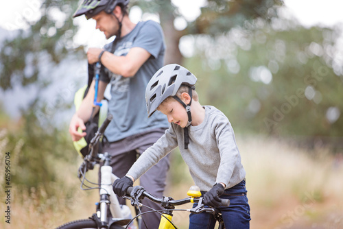 family of two, young father and cheerful son, enjoying bike riding, active family concept