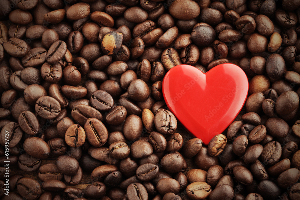 Textures of roasted coffee beans with red heart for background