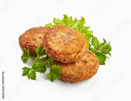 Photos Three fried breaded cutlet with lettuce and parsley isolated on white background