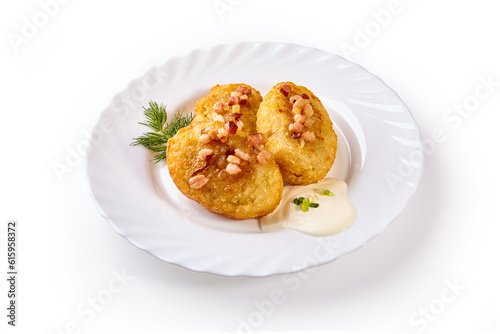 Potato dumplings - a traditional regional dish. Polish and Lithuanian cuisine. With fried bacon on a white plate.