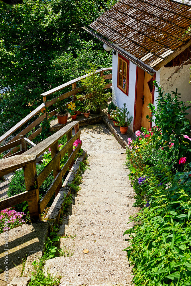 Hallstatt, Austria. Stone stairs among narrow antique streets and traditional austrian houses on slopes of knolls. Lake Hallstattersee.