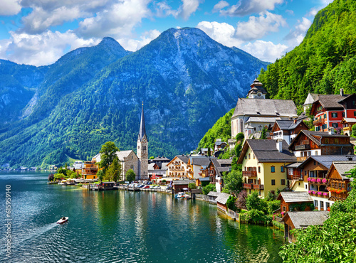 Hallstatt, Austria. View to Hallstattersee Lake and Alps mountains summits. Ancient houses at lake banks with chapel. Summer day. Blue sky with clouds. © Designpics