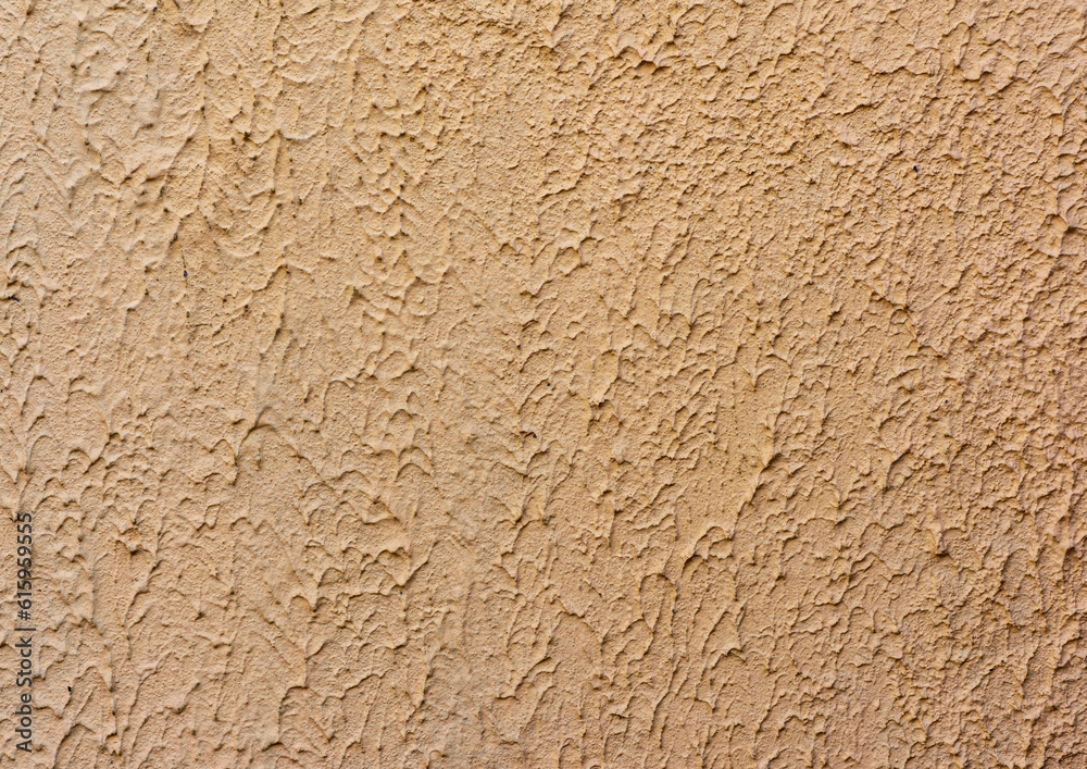 fragment of beige wall with decorative plaster of waves, full frame fragment of beige wall with decorative plaster of waves, full frame