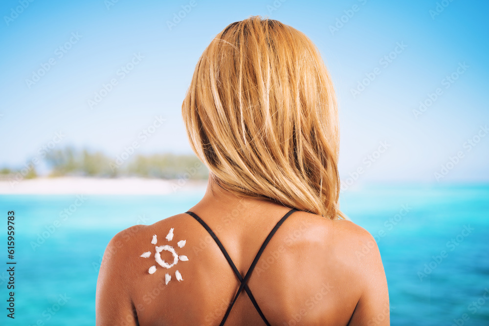 Fototapeta premium Girl at the beach in swimsuit with a sun made with sunscreen