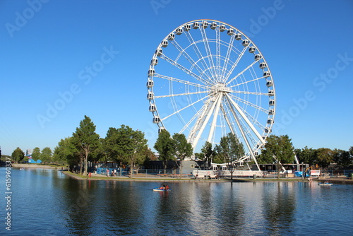 A view on the Montreal Ferris Wheel on an artificial island at the Old Port surrounded by waters of St-Lawrence river