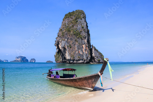 RAILAY BEACH, KRABI, THAILAND â?? APRIL 8 2015 Traditional Wooden Longtail Boat anchored on Railay Beach in Krabi Province Southern Thailand, Longtail Boats are used as water taxis between the beaches
