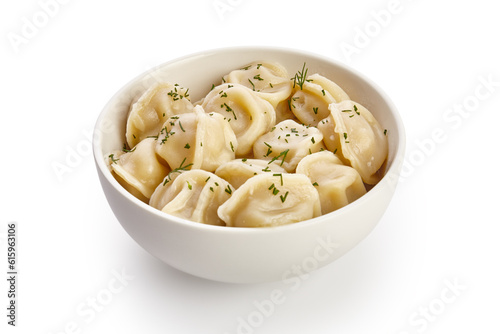 Bowl with tasty dumplings on white background