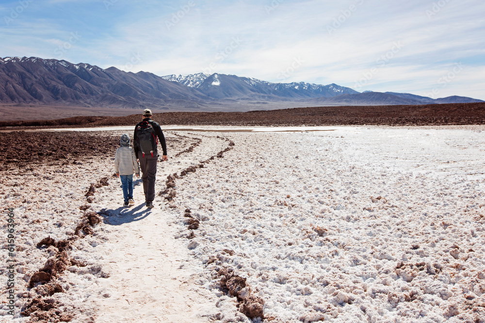 family of two, father and son, walking and hiking in lagunas escondidas, secret lagoons, in atacama desert, chile - driest place on earth, family adventure concept