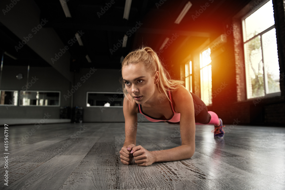 Determined blonde girl working out at a gym Determined blonde girl working out at a gym