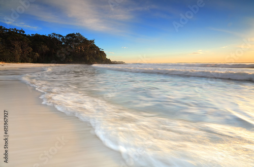 Soft motion in the waves as they ebb and flow onto the shore in early morning light.