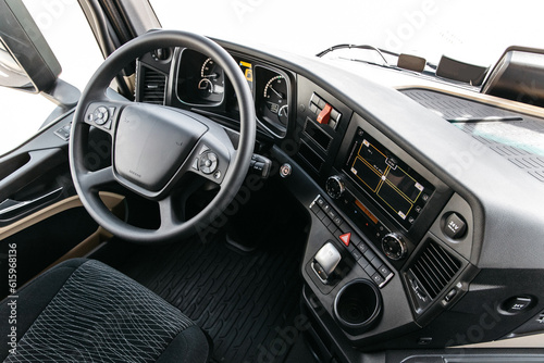 view inside the cabin of a heavy new modern truck. steering wheel, navigation system, cameras, multimedia © AvokadoStudio