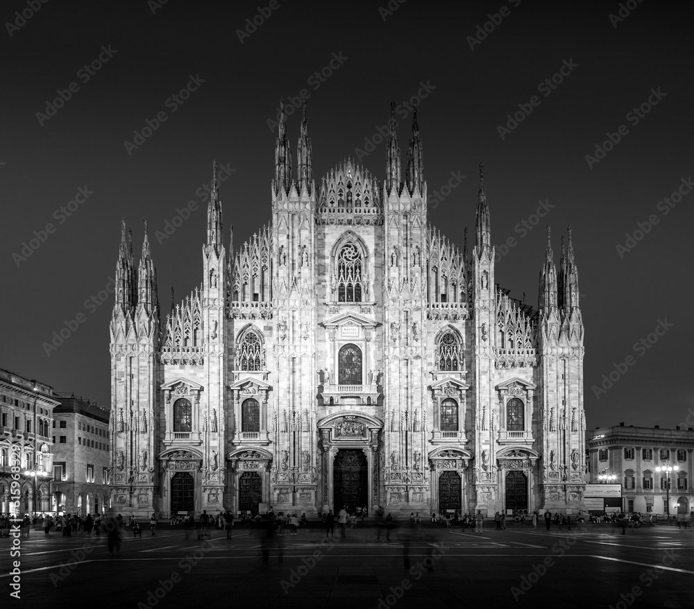 MILAN, ITALY - APRIL 28th, 2018: turists during blue hour taking pictures in Duomo Square , the main landmark of the city.