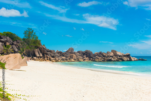 Beautifully shaped granite boulders and a perfect white sand at Grand Anse, La Digue island, Seychelles