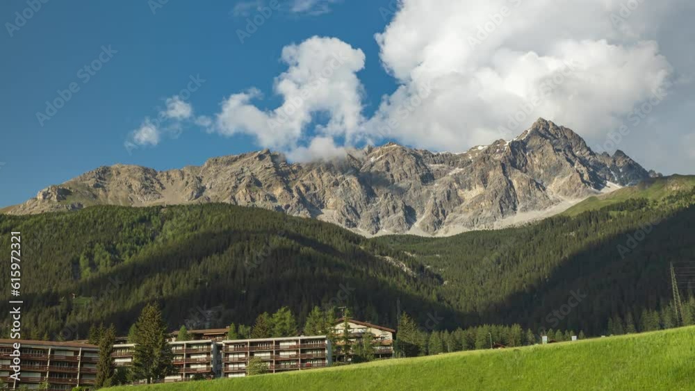 Timelapse of dancing clouds above the mountains. Mountain landscape. Piz Mitgel mountain, Albula Range of the Alps, Savognin, Surses, Canton of Graubünden in Switzerland Timelapse of dancing clouds above the mountains. Mountain landscape. Piz Mitgel mountain, Albula Range of the Alps, Savognin, Surses, Canton of Graubünden in Switzerland