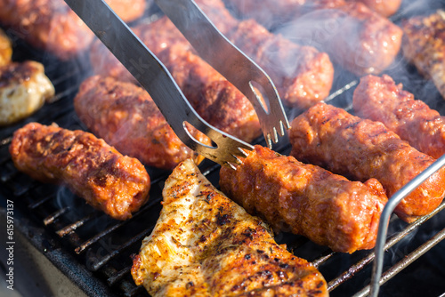 Close up of traditional Romanian food made of pork/beaf meat called mici or mititei fried on mangal barbeque grill