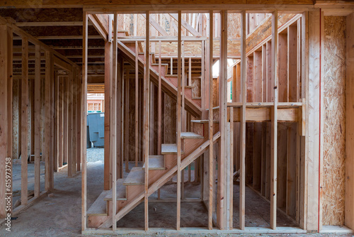 New home construction interior wood stud framing ceiling beams entryway staircase