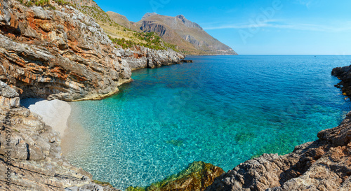 Paradise sea bay with azure water and beach. View from coastline trail of Zingaro Nature Reserve Park, between San Vito lo Capo and Scopello, Trapani province, Sicily, Italy. Two shots stitch panorama photo