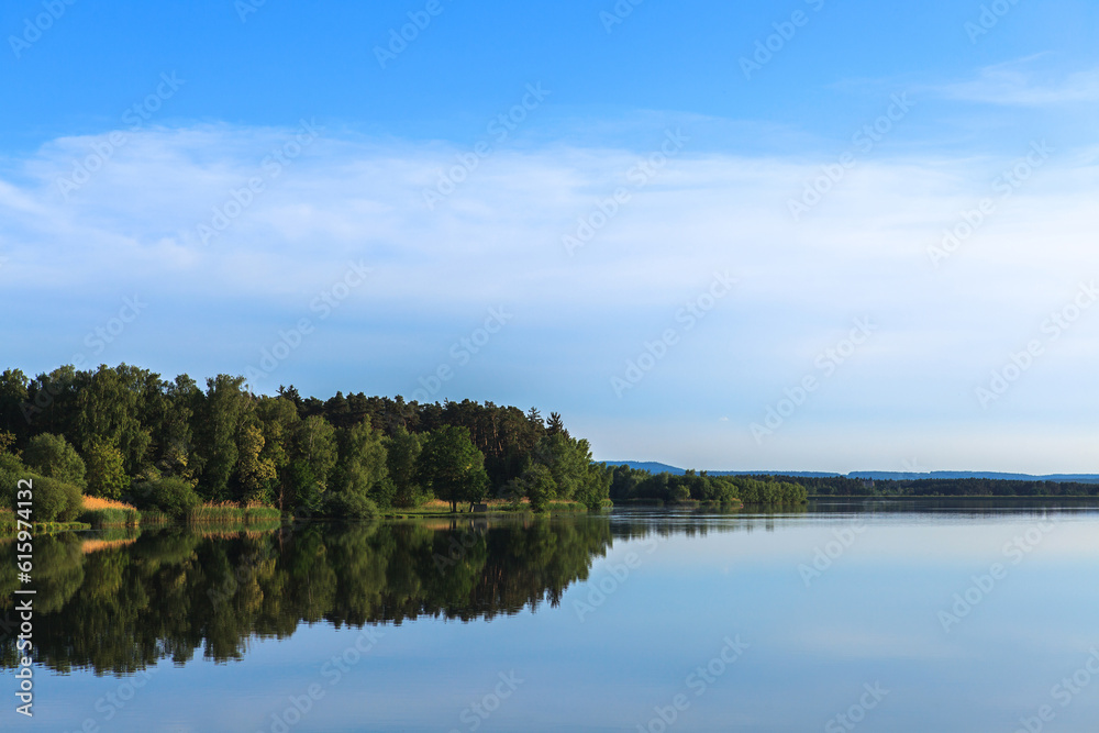 Lake Roth in Bavaria at sunset of a summer day with the outburst of a blue sky