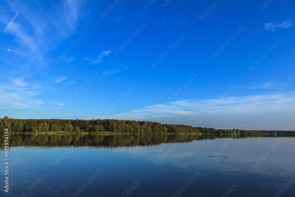 Lake Roth in Bavaria at sunset of a summer day with the outburst of a blue sky