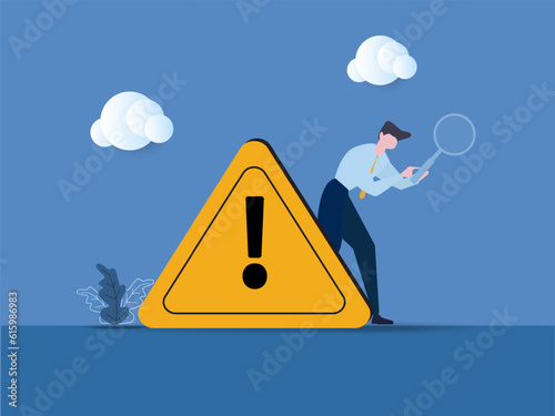 Businessman with magnifier monitor and investigate incident with exclamation attention sign, Incident management, root cause analysis or solving problem, identify risk or critical failure concept.