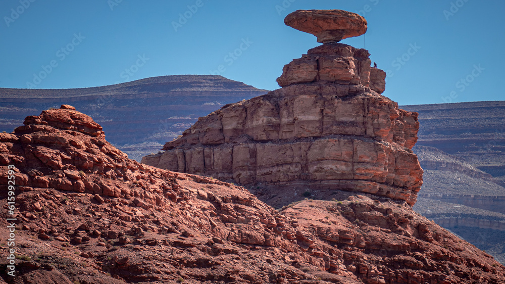 Mexican Hat Rock with climber on a clear, sunny morning | Mexican Hat, Utah, USA