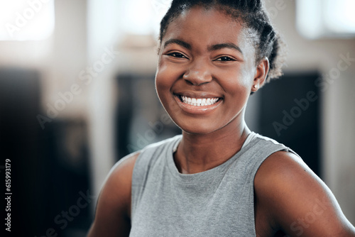 Smile, portrait or happy black woman at gym for a workout, exercise or training for healthy fitness or wellness. Face of sports girl or proud African athlete smiling or relaxing with positive mindset