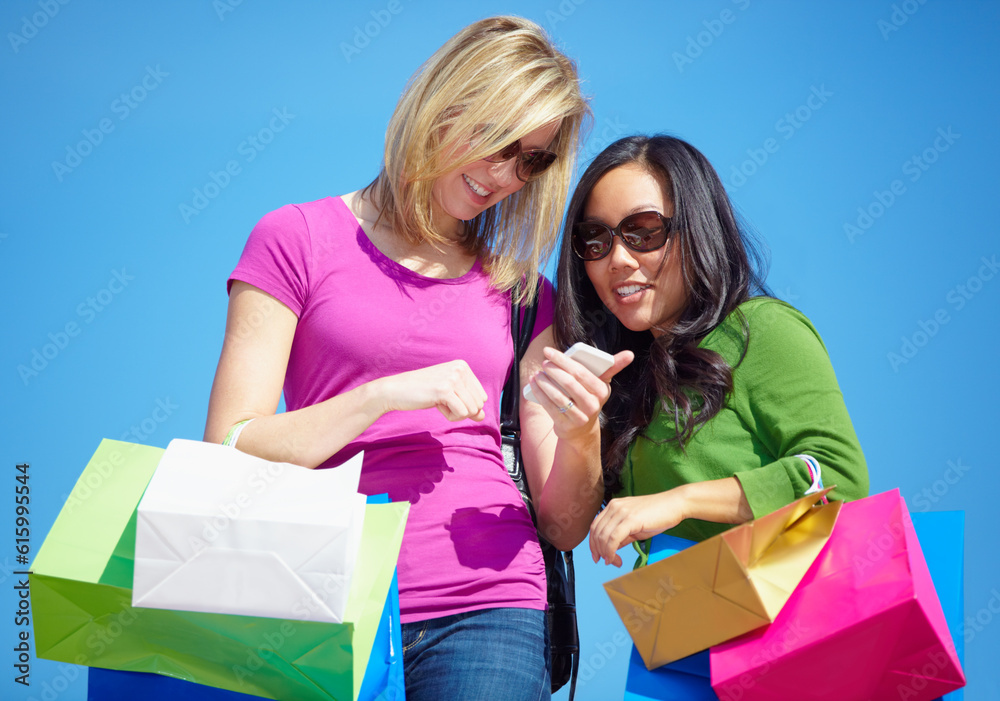 Happy woman, friends and phone with shopping bags for fashion, social media or purchase outdoors. Women shoppers in colorful clothing on mobile smartphone app for payment, buying or ecommerce Happy woman, friends and phone with shopping bags for fashion, social media or purchase outdoors. Women shoppers in colorful clothing on mobile smartphone app for payment, buying or ecommerce