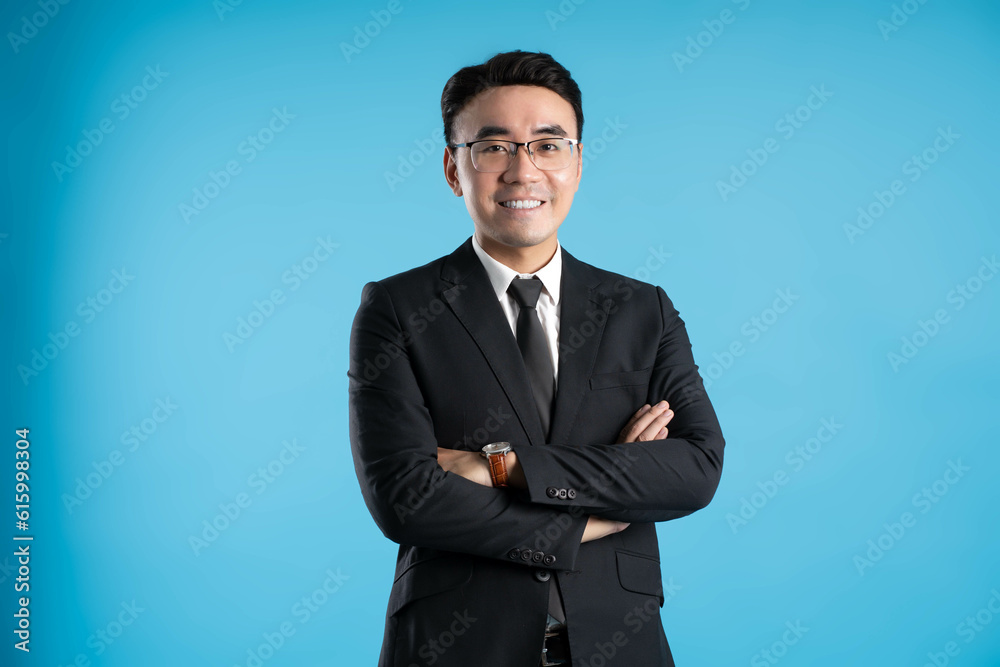 image of young businessman posing on blue background image of young businessman posing on blue background