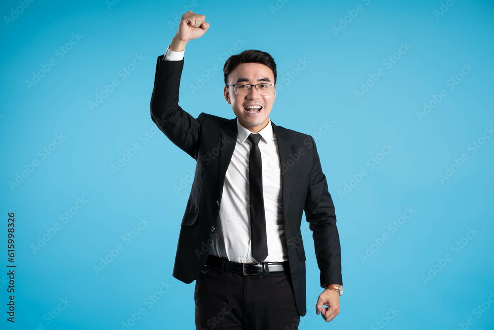 image of young businessman posing on blue background image of young businessman posing on blue background