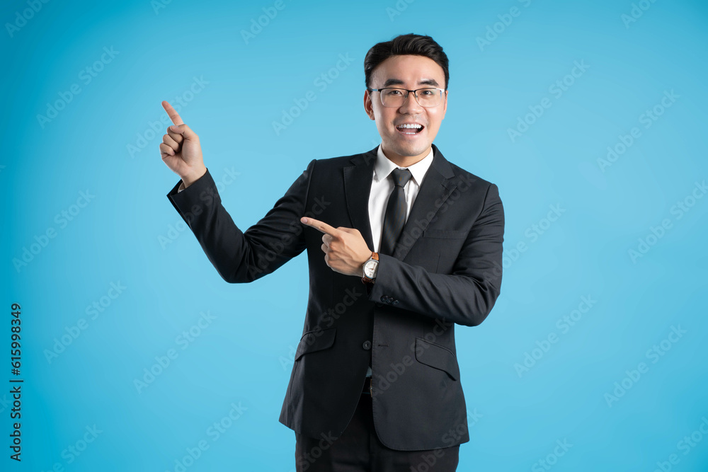 image of young businessman posing on blue background image of young businessman posing on blue background