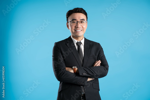 Obraz na plátně image of young businessman posing on blue background