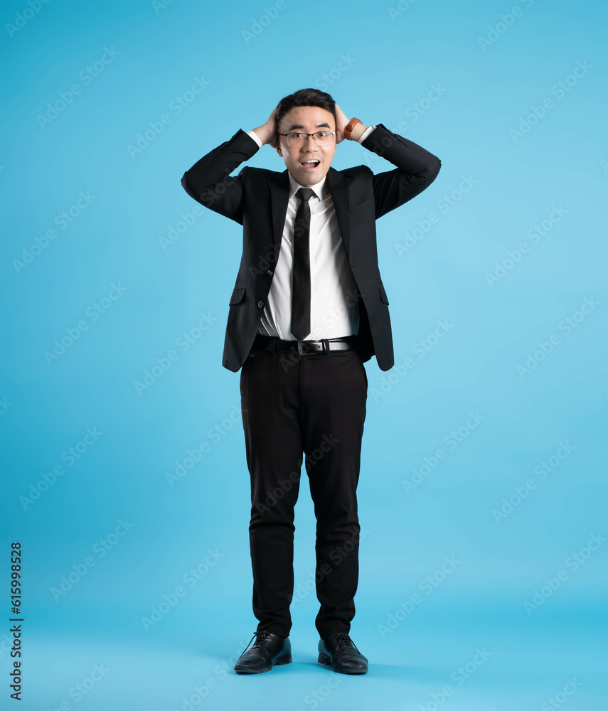 full body image of young businessman posing on blue background full body image of young businessman posing on blue background