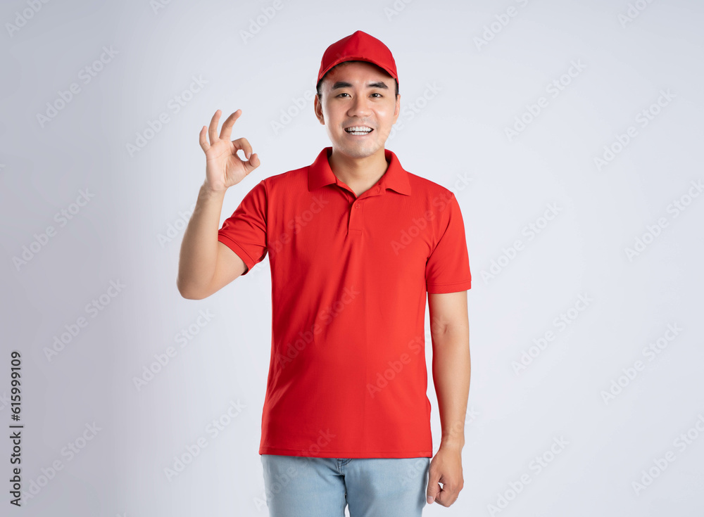image of asian delivery man posing on white background image of asian delivery man posing on white background