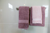 Closeup white and brown towel hanging on clothesline in the bathroom with space for texts