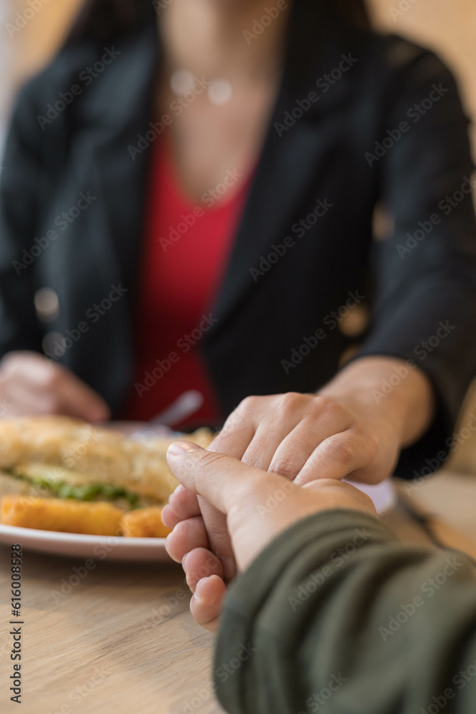 romantic date in a restaurant, holding hands and enjoying food plate, expression of emotions and food