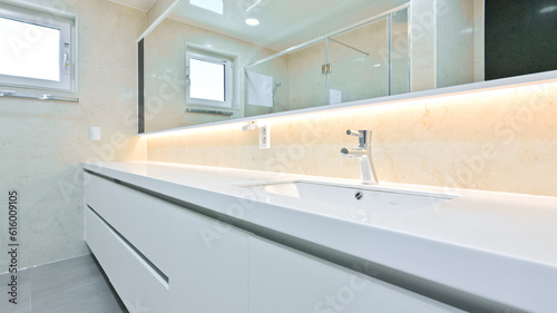 A bathroom with a horizontally long washbasin to make it feel like a hotel