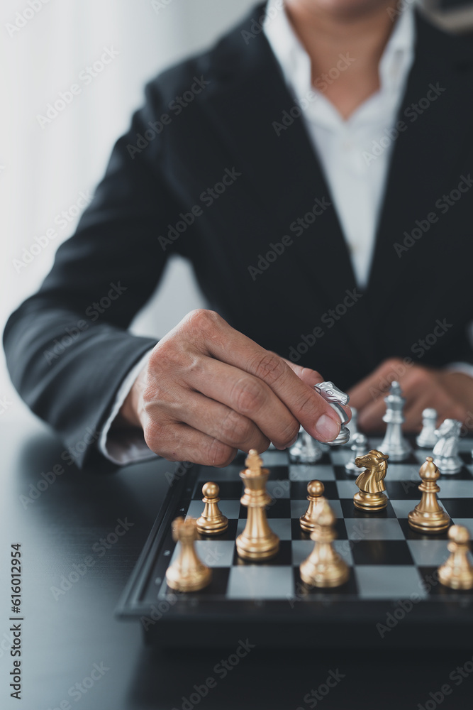 Investor playing chess board game conceptual image of businessman holding chess piece in business competition and risk management Plan a business strategy to beat your competitors. leadership concept